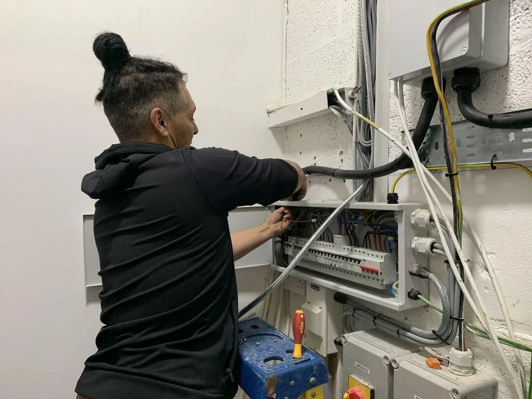 Electrician connecting a new consumer unit